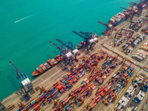 container cargo ship in the export and import business and logistics shipping to the harbor 300x225
